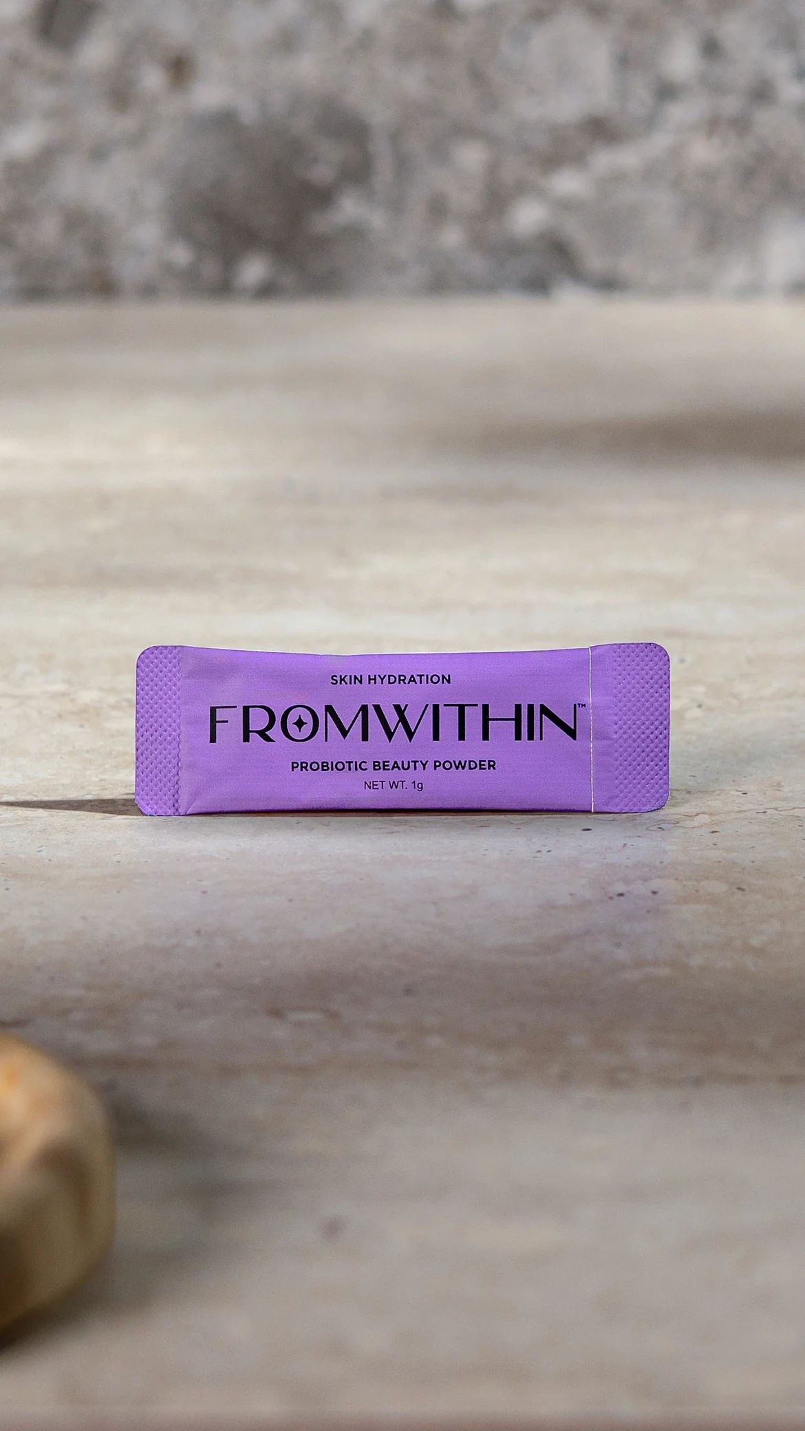 A FROMWITHIN sachet standing on travertine